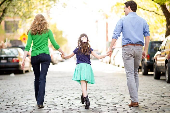 Relaxed family portraits, holding hands on a walk. NYC child and family photography.