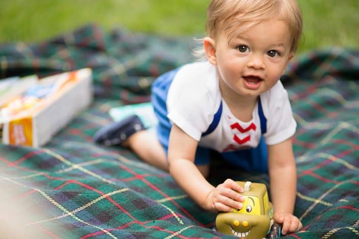 Baby playing at a picnic in the park. Child portraits. Relaxed, candid, fun New Jersey family photography.