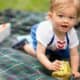 Baby playing at a picnic in the park. Child portraits. Relaxed, candid, fun New Jersey family photography.