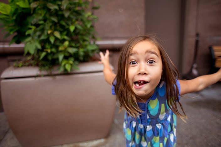 Silly, natural family photos, daughter playing outside. NYC child and family photography.
