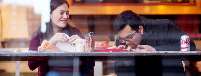 NYC casual engagement photo at classic pizza joint on the Upper West Side