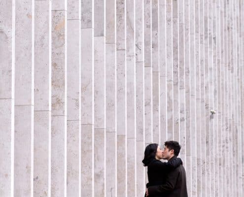 Lincoln Center engagement photo in NYC with monochromatic wall in the background