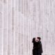 Lincoln Center engagement photo in NYC with monochromatic wall in the background