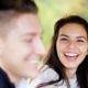 Woman laughing as her fiance drives a golf cart during engagement shoot at Jasna Polana in Princeton, NJ.