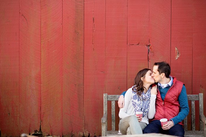 Terhune Orchards engagement photo in front of the red barn. Photographed in Princeton, NJ.