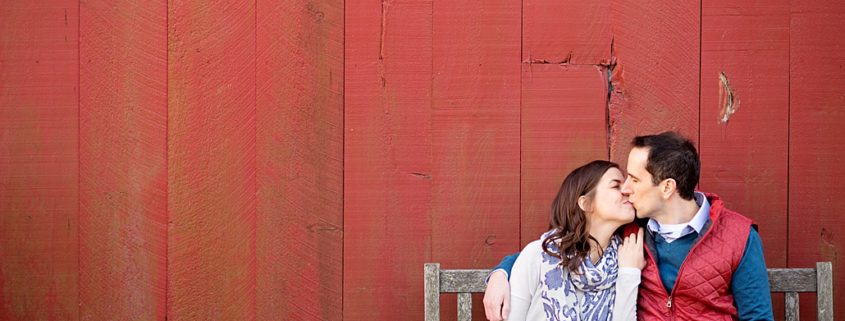 Terhune Orchards engagement photo in front of the red barn. Photographed in Princeton, NJ.