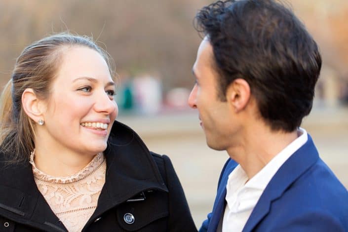 Candid engagement photo in Central Park: closeup of couple laughing
