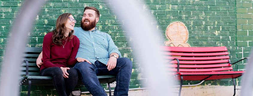 Brooklyn engagement photo - couple sitting on park bench and chatting