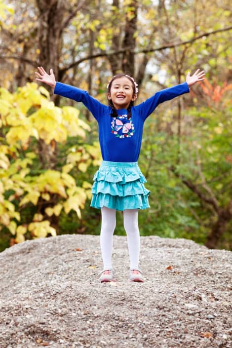 Daughter playing outside, hands up, climbing a rock. Silly, fun child Delaware & Raritan Canal State Park Trail Kingston portraits. New Jersey family photography