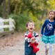 Brother and sister running and playing together at the park. Natural, candid child and family portraits. New Jersey family photography.