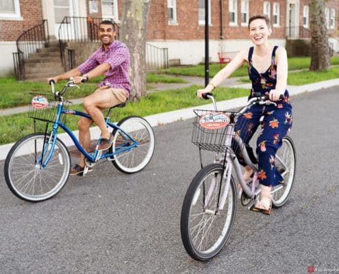 governors island engagement photo cycling bike velo couple engaged nyc fun smile skyscraper city