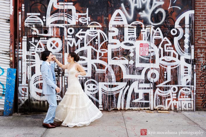 bride and groom dance twirl on the street Roberta’s Pizza Florals restaurant Williamsburg, Brooklyn wedding, graffiti