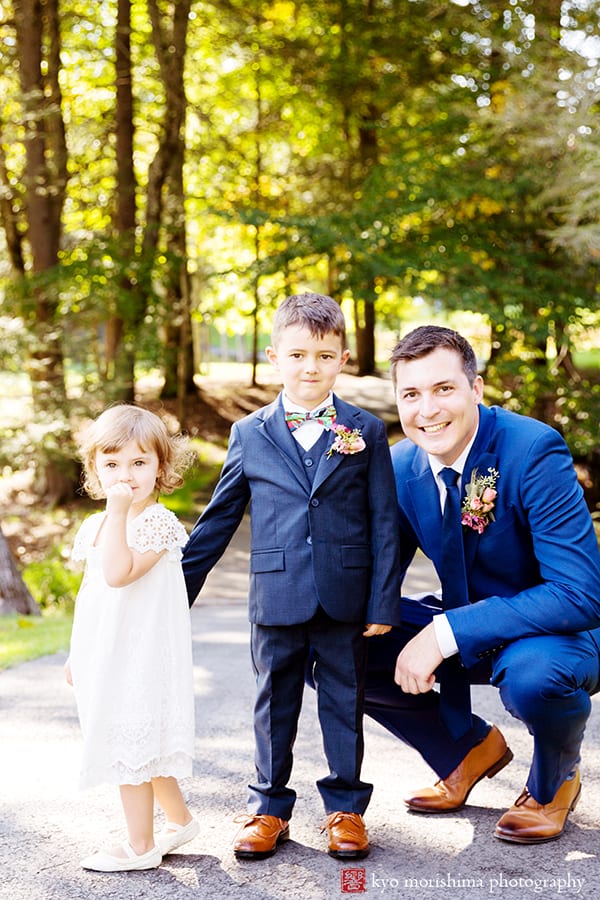 Groom poses with ring bearer and flower girl along wooded path in Woodloch Pines, cute wedding pictures, ourtood wedding photography ideas, Poconos wedding photographer. Woodloch Pines wedding.