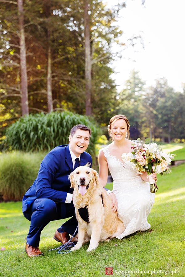 Bride and groom pose outside with their dog golden retriever at Woodloch Pines resort, white and pale peach bouquet with burgundy accents by Fox Hill Farm Experience, Castle Couture wedding gown, cobalt blue groom's suit, outdoor poconos wedding photographer., Woodloch Pines wedding, cute wedding pictures