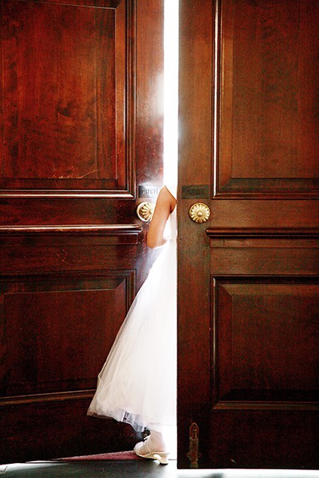 Flower girl between doors waiting for bride to arrive t Unitarian church NYC