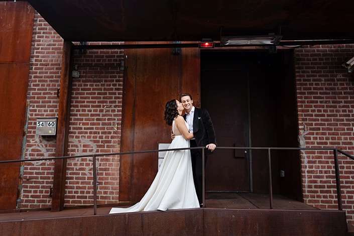 Bride kissed groom in front of Wythe Hotel Brooklyn wedding portrait