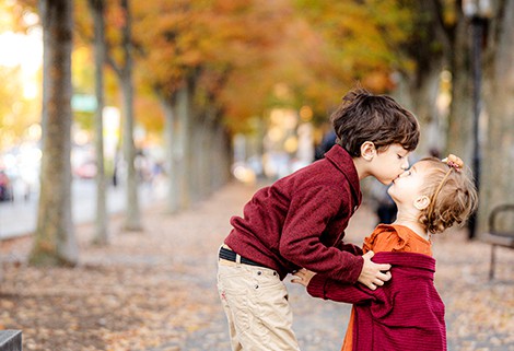 sister and brother kiss Princeton NJ autumn family portrait
