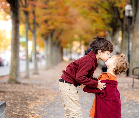 sister and brother kiss Princeton NJ autumn family portrait