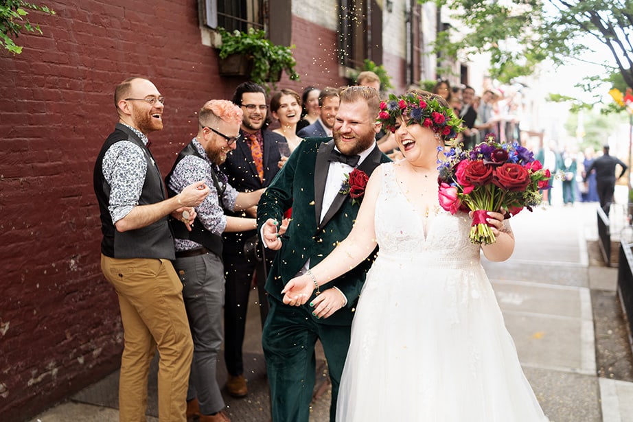 Radegast Hall Williamsburg Brooklyn NYC rad summer wedding bride and groom smiling happy cerebrated and cheered from friends and family on the street