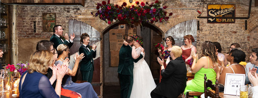 Radegast Hall williamsburg brooklyn nyc rad summer wedding bride and groom ceremony kiss ceremony happy