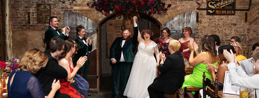 Radegast Hall williamsburg brooklyn nyc rad summer wedding bride and groom ceremony hand up ceremony happy