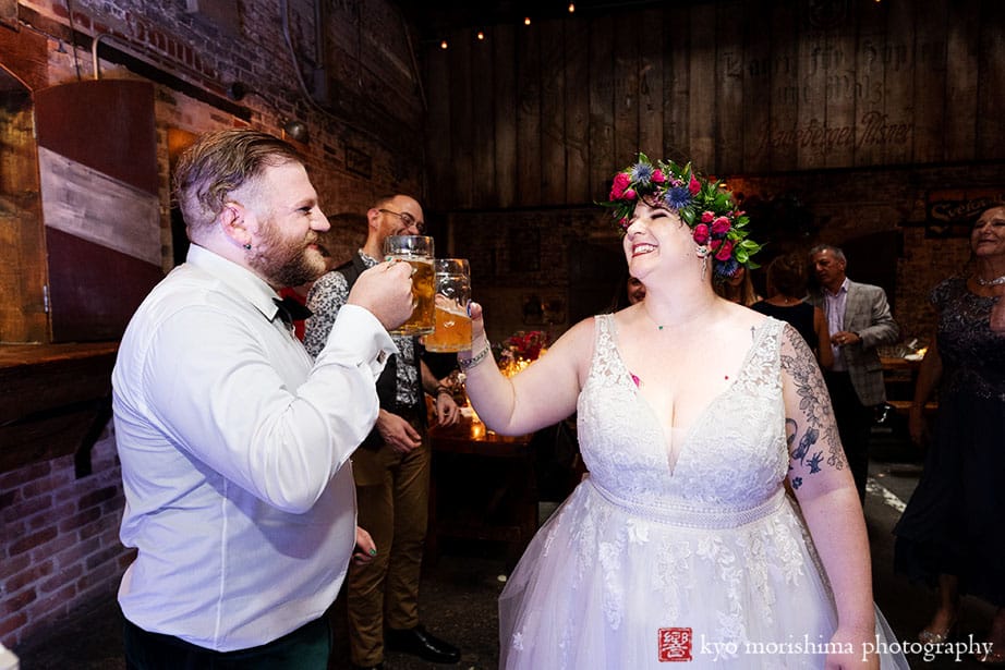 Radegast Hall Williamsburg Brooklyn wedding bride and groom cheering hitting their beer mugs