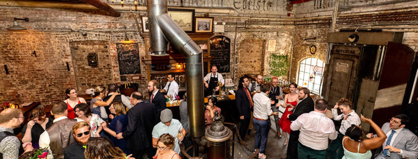 Radegast Hall williamsburg brooklyn nyc rad summer wedding guests having fun birds eye view reception hall room