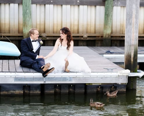Molly Pitcher Inn Red Bank bride and groom wedding portrait on a dock with ducks