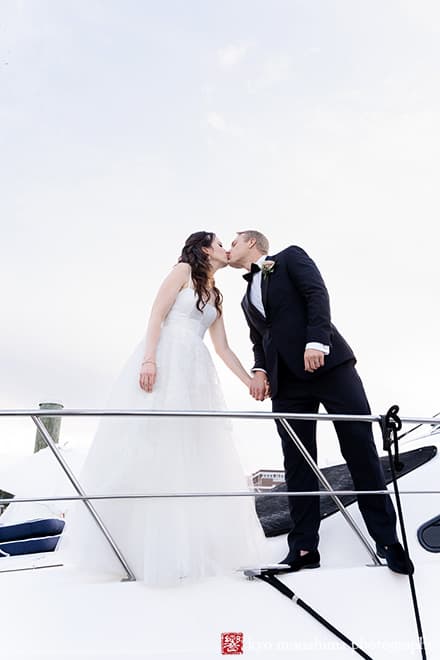 Molly Pitcher Inn Red Bank bride and groom bay ocean wedding portrait kiss on a boat cruiser