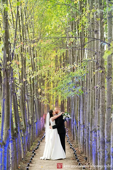 Rat's Restaurant, Grounds for Sculpture, outdoor fall dusk wedding portrait, bride and groom walk tree path kiss