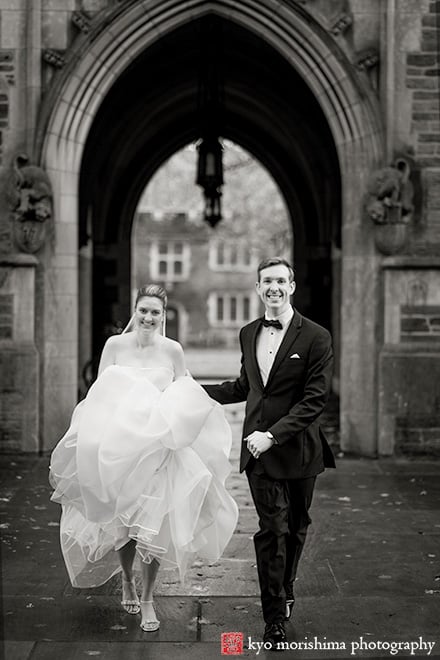 winter Princeton University campus wedding bride & groom newlyweds portrait running having fun smiling going through an arch of archtecture