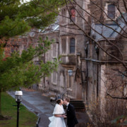 winter Princeton University campus wedding bride & groom newlyweds portrait holding hands kiss dusk architecture