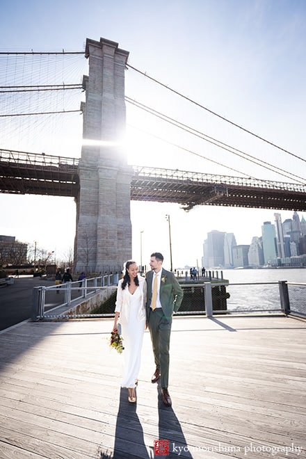 Dumbo Brooklyn, NYC, bride and groom, newlyweds outdoor street portrait in front of Brooklyn Bridge the sun backlit