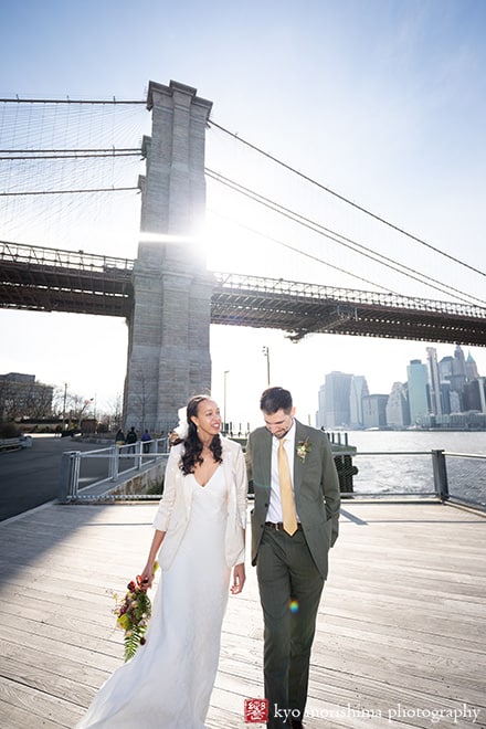 Dumbo Brooklyn, NYC, bride and groom, newlyweds outdoor street portrait in front of Brooklyn Bridge the sun backlit
