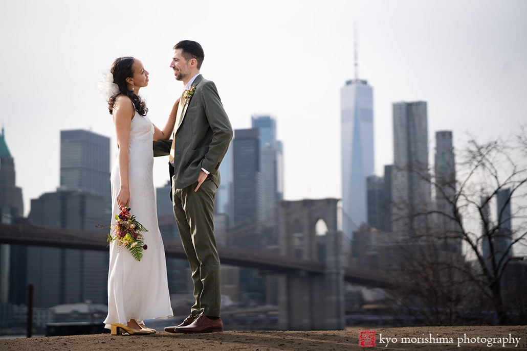 Vinegar Hill House, Dumbo Brooklyn, NYC, bride and groom, newlyweds outdoor street portrait in front of Brooklyn Bridge World Trade Center and East River smile