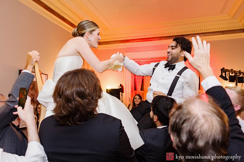 Bride and Groom on chairs up in the air wedding reception at Princeton Prospect House & Garden