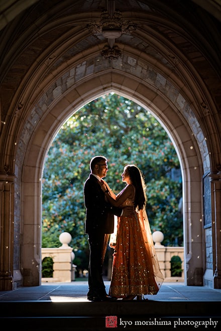 Princeton University Campus Rockefeller College NJ Indian engagement documentary canded portrait session fall autumn a couple saree dress arch hallway European brick building wooded door old kiss silhouette