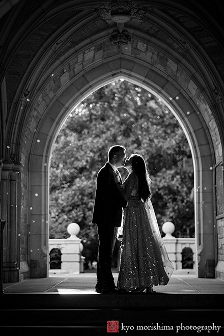 Princeton University Campus Rockefeller College NJ Indian engagement documentary canded portrait session fall autumn a couple saree dress arch hallway European brick building wooded door old kiss silhouette