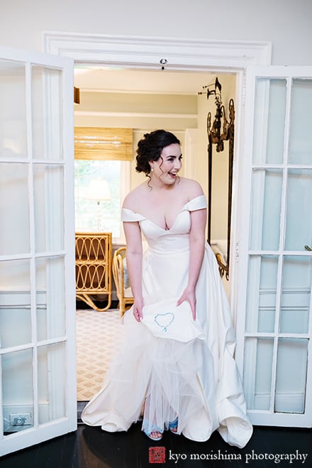 at Fall The Inn at Fernbrook Farm Chesterfield NJ Wedding bride showing off her special blue hart stitching on her dress while getting ready in a bridal suite room