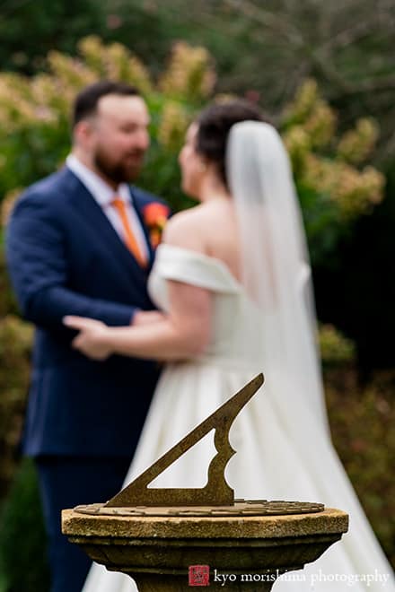 at Fall The Inn at Fernbrook Farm Chesterfield NJ Wedding bride and groom talking holding hands first look holding beautiful bouquet vintage antique sun clock