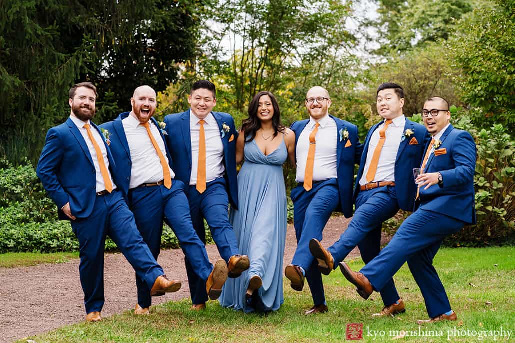 groomsmen and grooms woman having fun goofing around getting together smiling laughing in the field at Fall The Inn at Fernbrook Farm Chesterfield NJ Wedding
