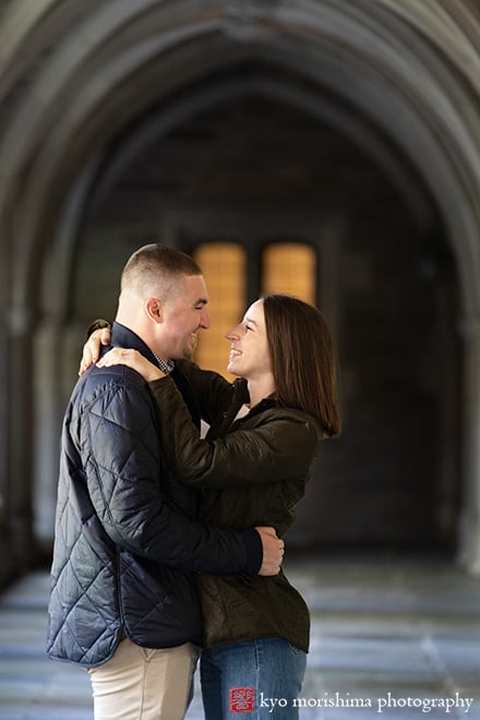 fall autumn Princeton University campus NJ engagement proposal couple outdoor portrait photography session hug holding each other smiling holder hall Rockefeller College