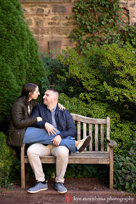 fall autumn Princeton University campus NJ engagement proposal couple outdoor portrait photography session sitting on a bench together looking at each other smiling