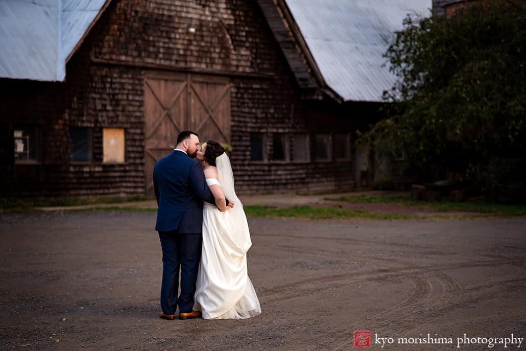 Fall The Inn at Fernbrook Farm Chesterfield NJ Wedding bride and groom outdoor sunset portrait picture by rustic barn building kiss
