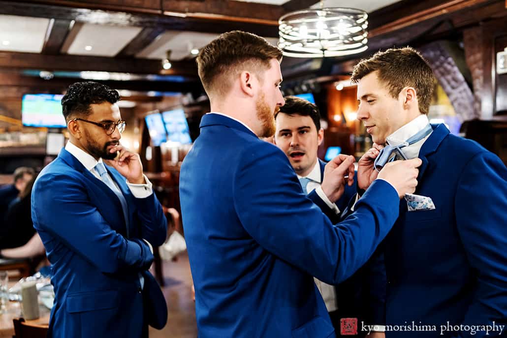 Nassau Inn Princeton NJ wedding groom getting ready groomsmen helping putting tie on fun laughing at Tap Room