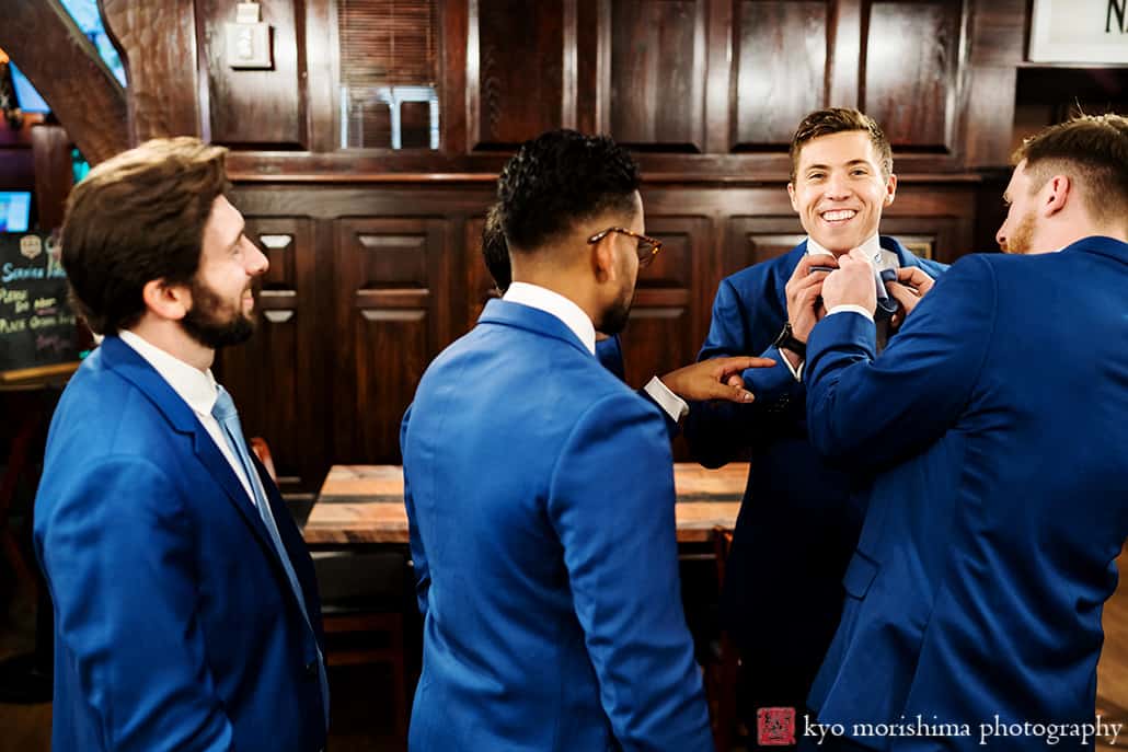 Nassau Inn Princeton NJ wedding groom getting ready groomsmen helping putting tie on fun laughing