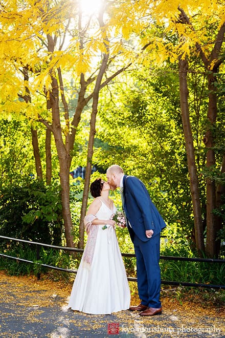 Fall outdoor Brooklyn Bridge Park street wedding portrait newlyweds bride and groom Manhattan NYC kiss