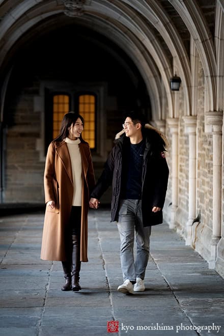 winter snow proposal portrait Rockefeller College Holder Hall Princeton University NJ NYC couple holding hands taking a walk smiling