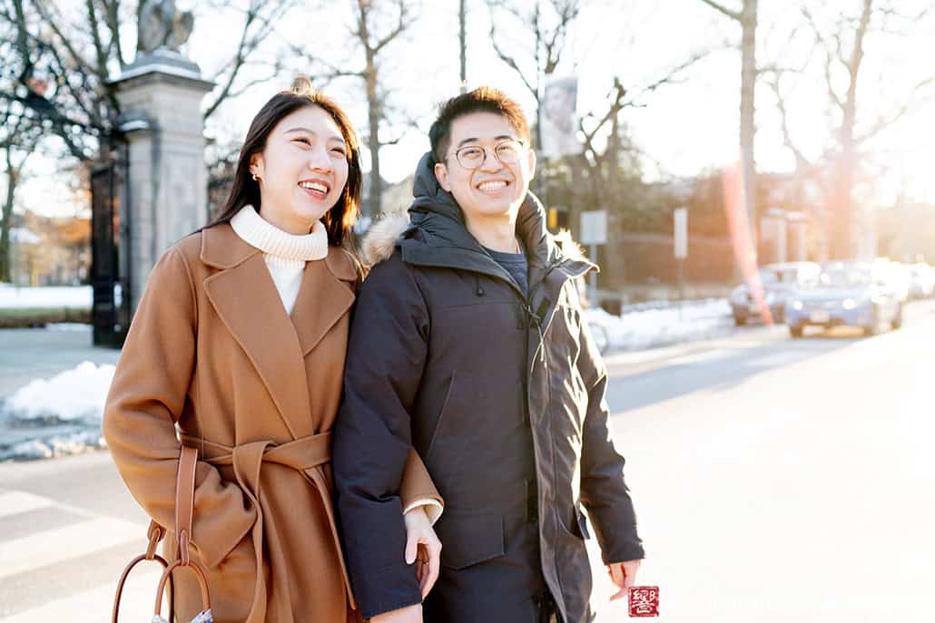 winter snow proposal engagement outdoor portrait Princeton NJ NYC couple holding arms crossing Nassau Street