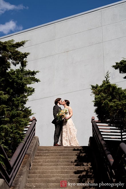 Spring Morris Museum Wedding with Potted Plants Morristown NJ bride groom outdoor portrait kiss at the top of stairs